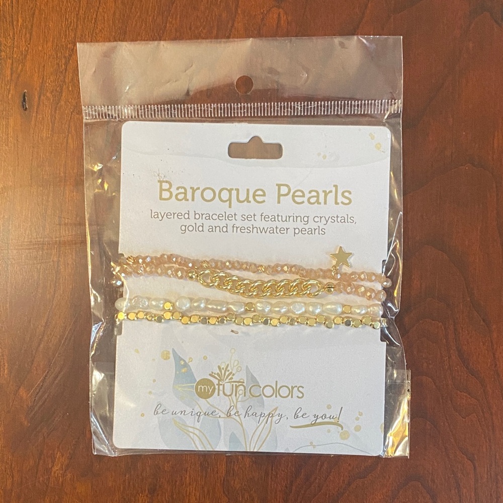 Layered bracelet set featuring crystals,gold and fresh water pearls. NWT